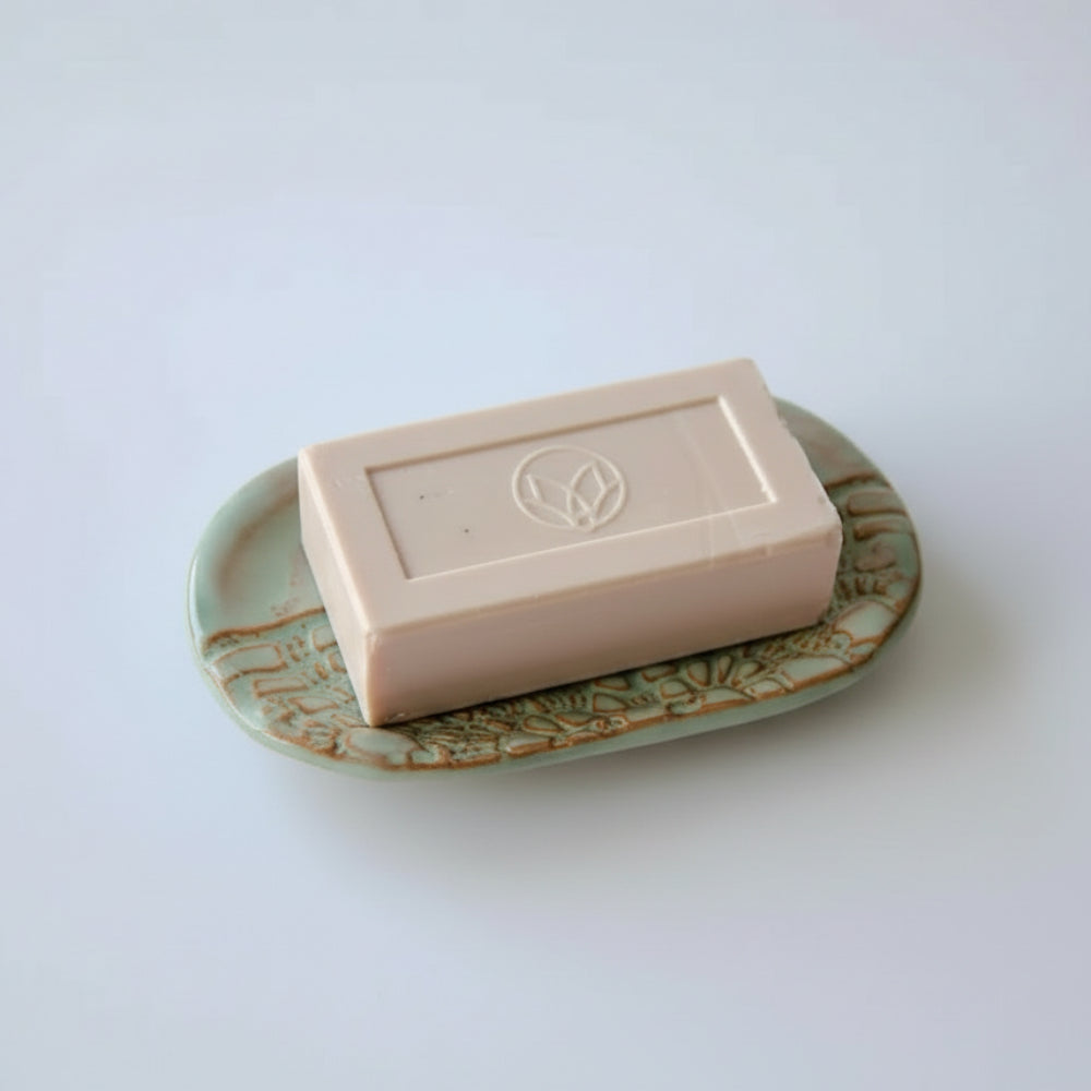 Light pink soap with embossed leaf design on handmade eco-friendly soap dish