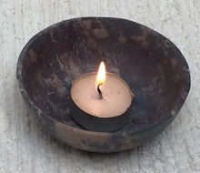 Lit handmade soapstone bowl with tea light candle