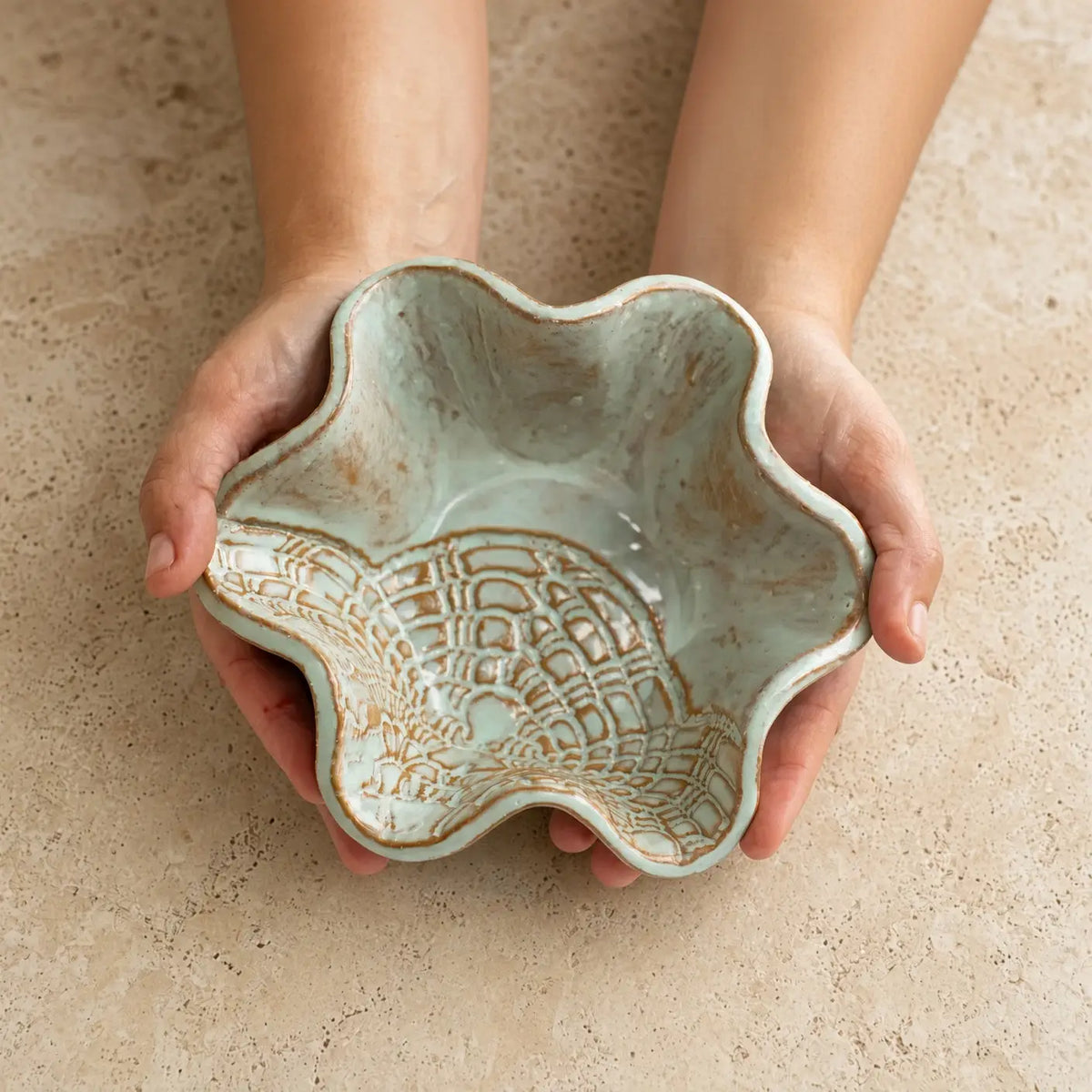 Handmade pottery mini blossom bowl in sage green with delicate lace imprints and brown woven pattern stoneware