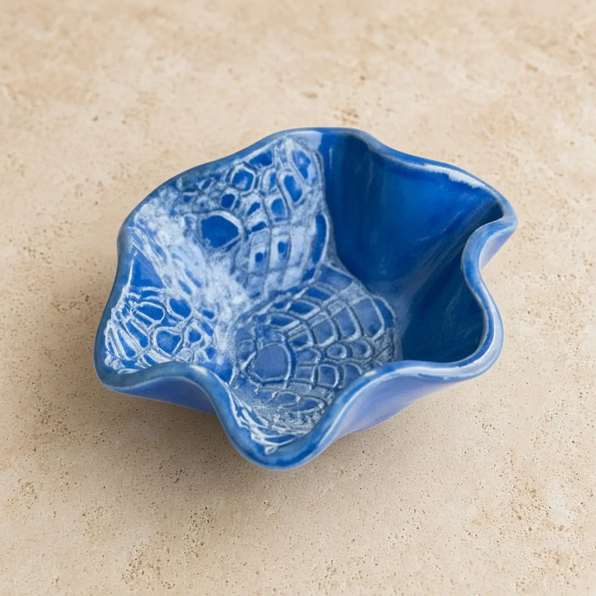 Handmade pottery mini blossom bowl in vibrant cobalt blue with embossed white crocodile-scale delicate lace imprints