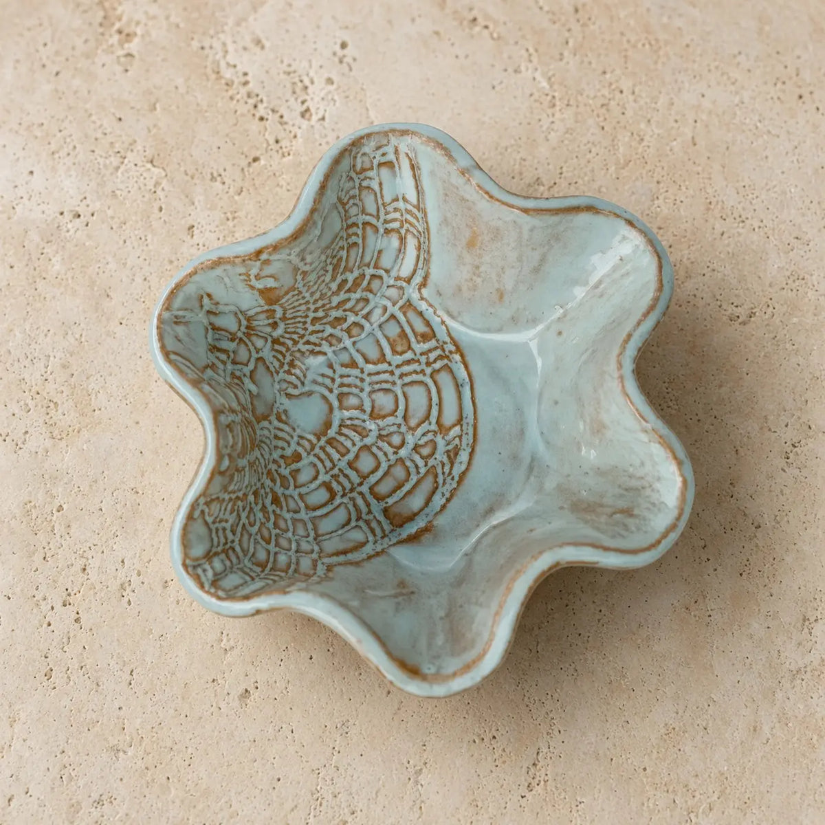 Handmade pottery mini blossom bowl in light blue stoneware with delicate lace imprints and scalloped edge design