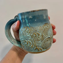 Handmade pottery mug with blue gradient glaze and wave design