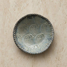 Handmade pottery ring dish in seafoam and blue with gray glaze, raised wave patterns, and twisted rope rim