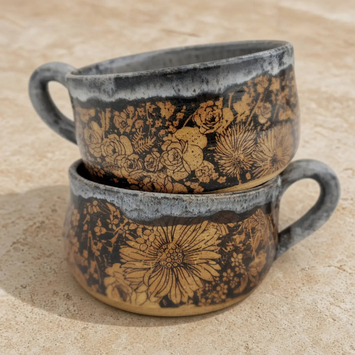 Handmade pottery soup bowl with rustic floral design in golden hues on dark stoneware glaze perfect for cozy meals