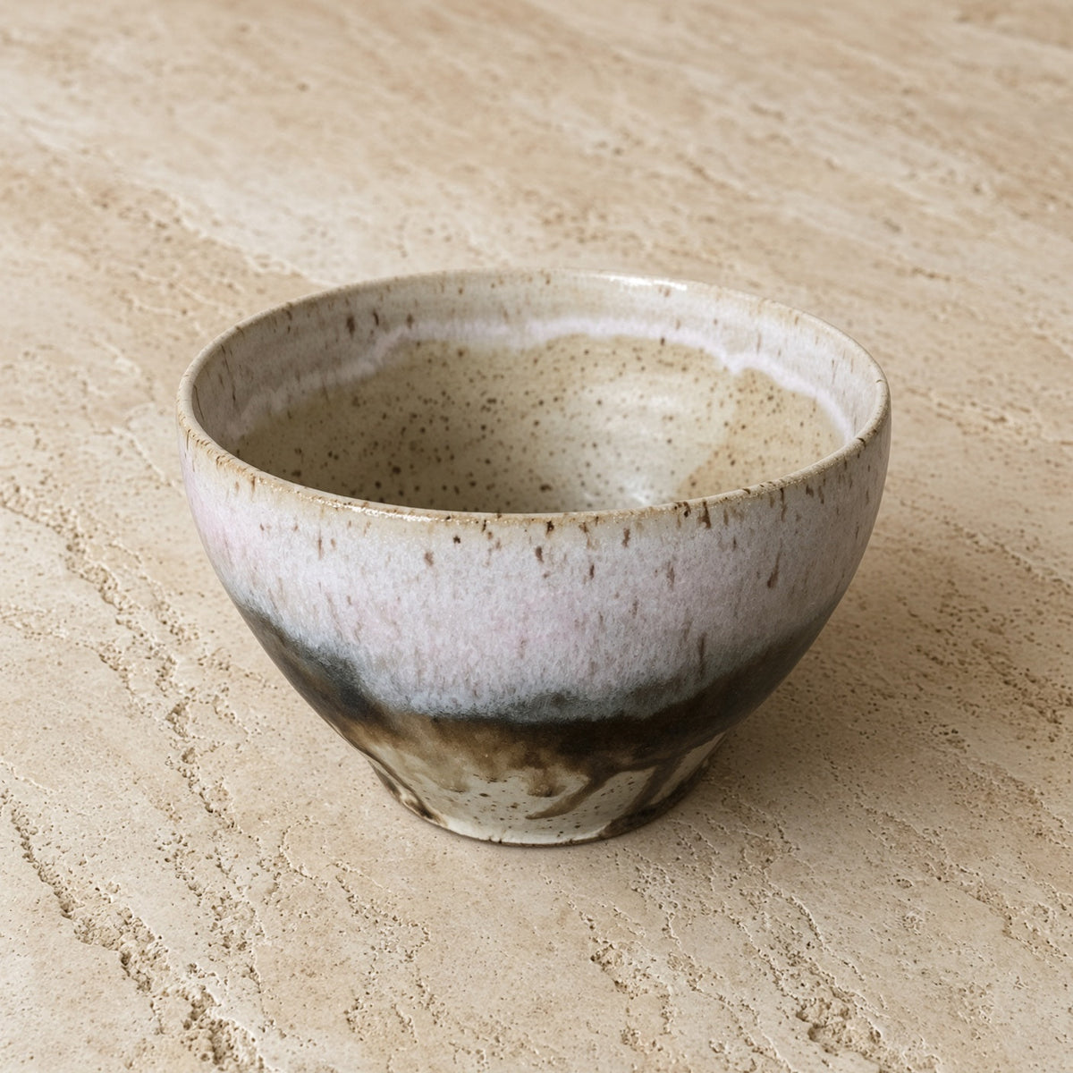 Handmade pottery soup bowl with unique borealis glaze featuring speckled white and dark brown streaks for organic appeal