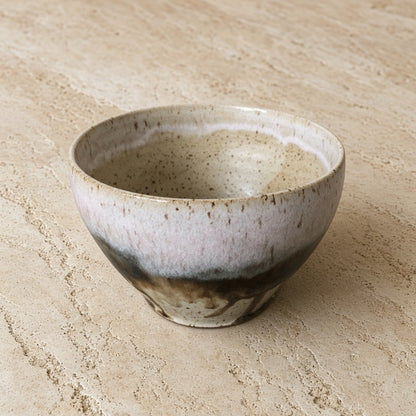 Handmade pottery soup bowl with unique borealis glaze featuring speckled white and dark brown streaks for organic appeal