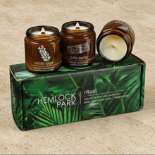 Set of three handmade ritual candles in amber glass jars with white wax wooden wicks and frankincense scents