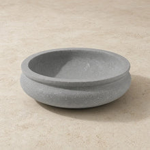 Handmade shallow soapstone bowl with gray stone, smooth rounded rim, subtle texture, perfect for treasures deserve care