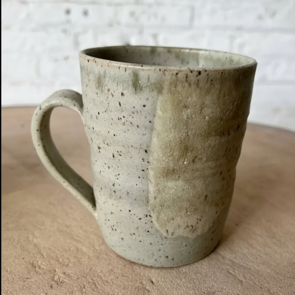 Handmade speckled ceramic mug with earthy textured glaze and eco-friendly color combo