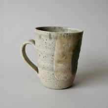 Handmade eco-friendly ceramic mug with speckled white glaze and green color combo