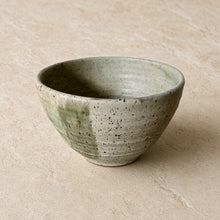Handmade speckled brown stoneware soup bowl with matte avocado green glaze and subtle horizontal ridges