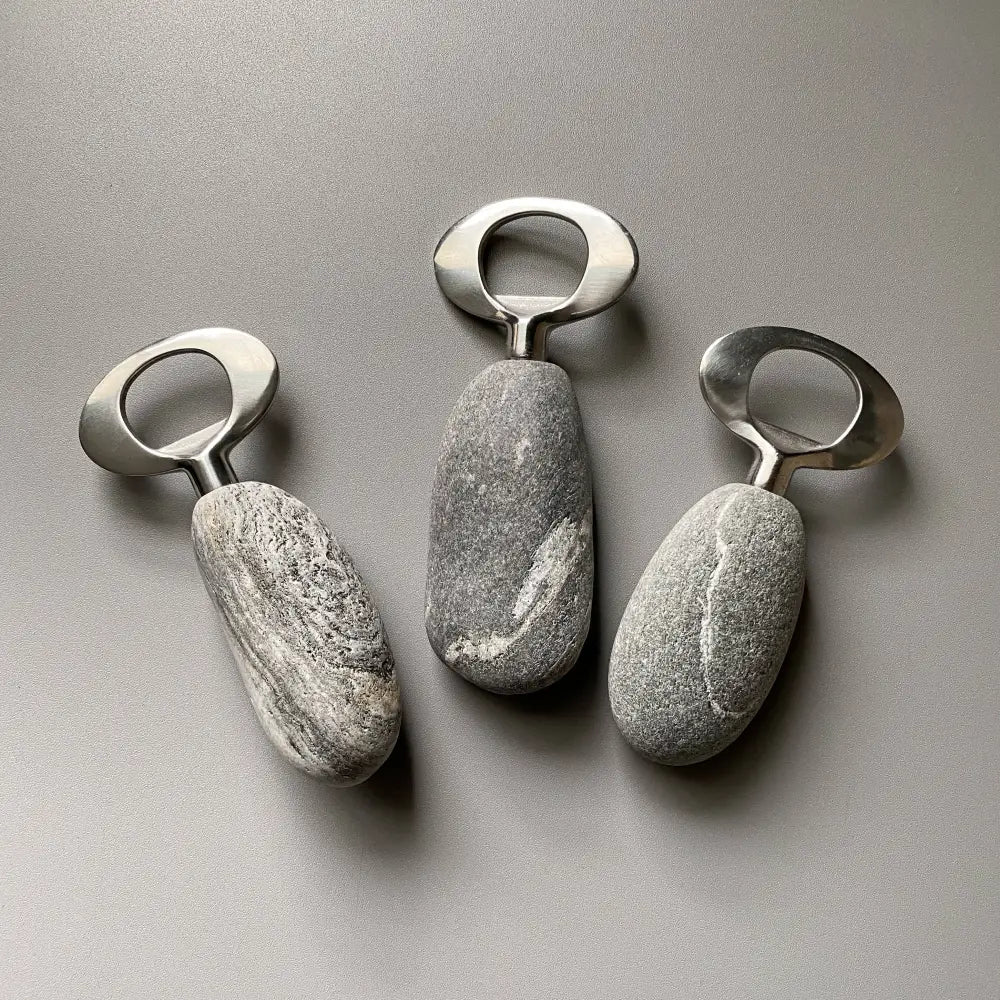 Handmade stainless steel bottle openers with natural stone texture and metallic rings