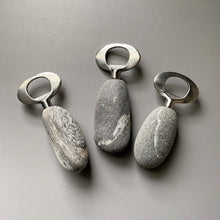 Handmade stainless steel bottle openers with natural stone texture and metallic rings