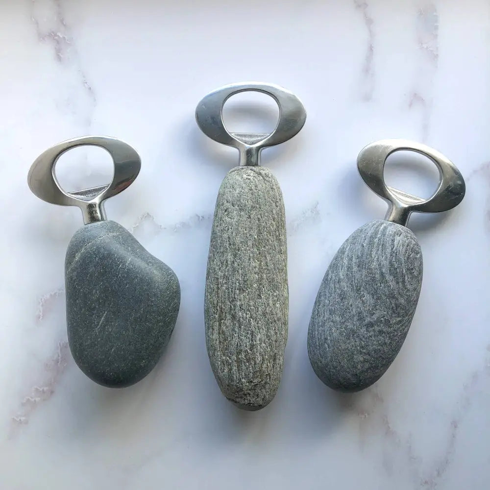 Handmade stone and stainless steel bottle opener with metallic ring and speckled gray texture