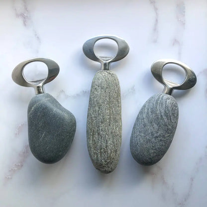 Handmade stone and stainless steel bottle opener with metallic ring and speckled gray texture
