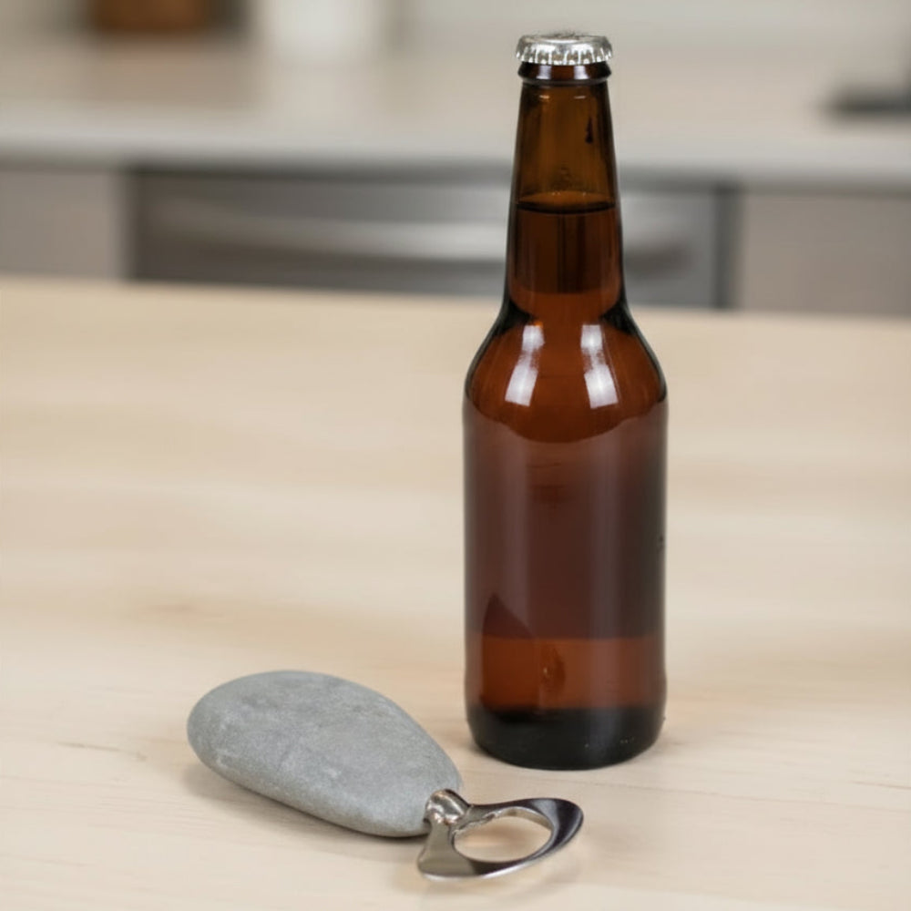 Handmade stone and stainless steel bottle opener with a brown glass beer bottle and keychain opener