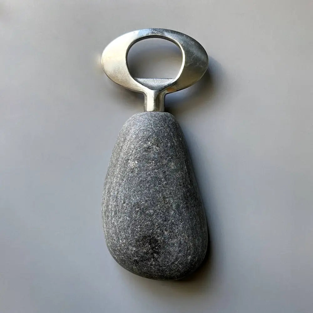 Handmade stainless steel bottle opener with natural stone handle and dark speckled design
