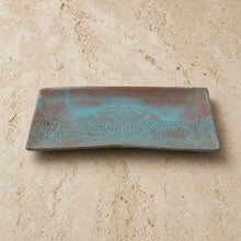 Handmade white ceramic serving platter with embossed lace pattern and turquoise brown patina finish featuring shell design