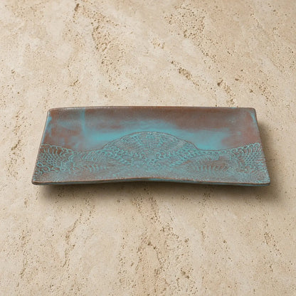 Handmade white ceramic serving platter with embossed lace pattern and turquoise brown patina finish featuring shell design