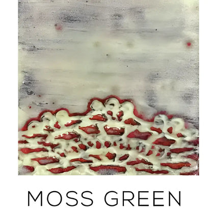 Handmade white ceramic serving platter with embossed lace pattern on moss green textured fabric background