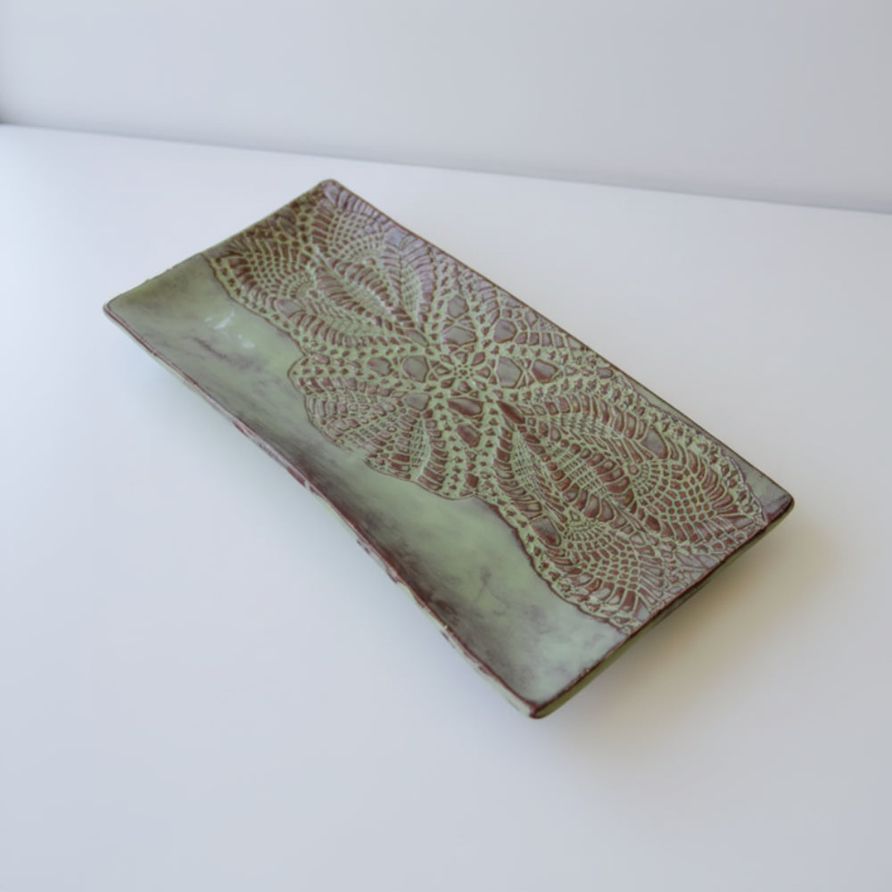 Handmade white ceramic platter with embossed lace pattern