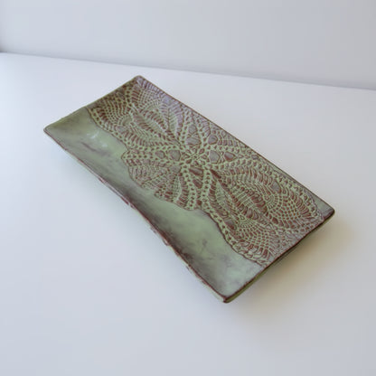Handmade white ceramic platter with embossed lace pattern
