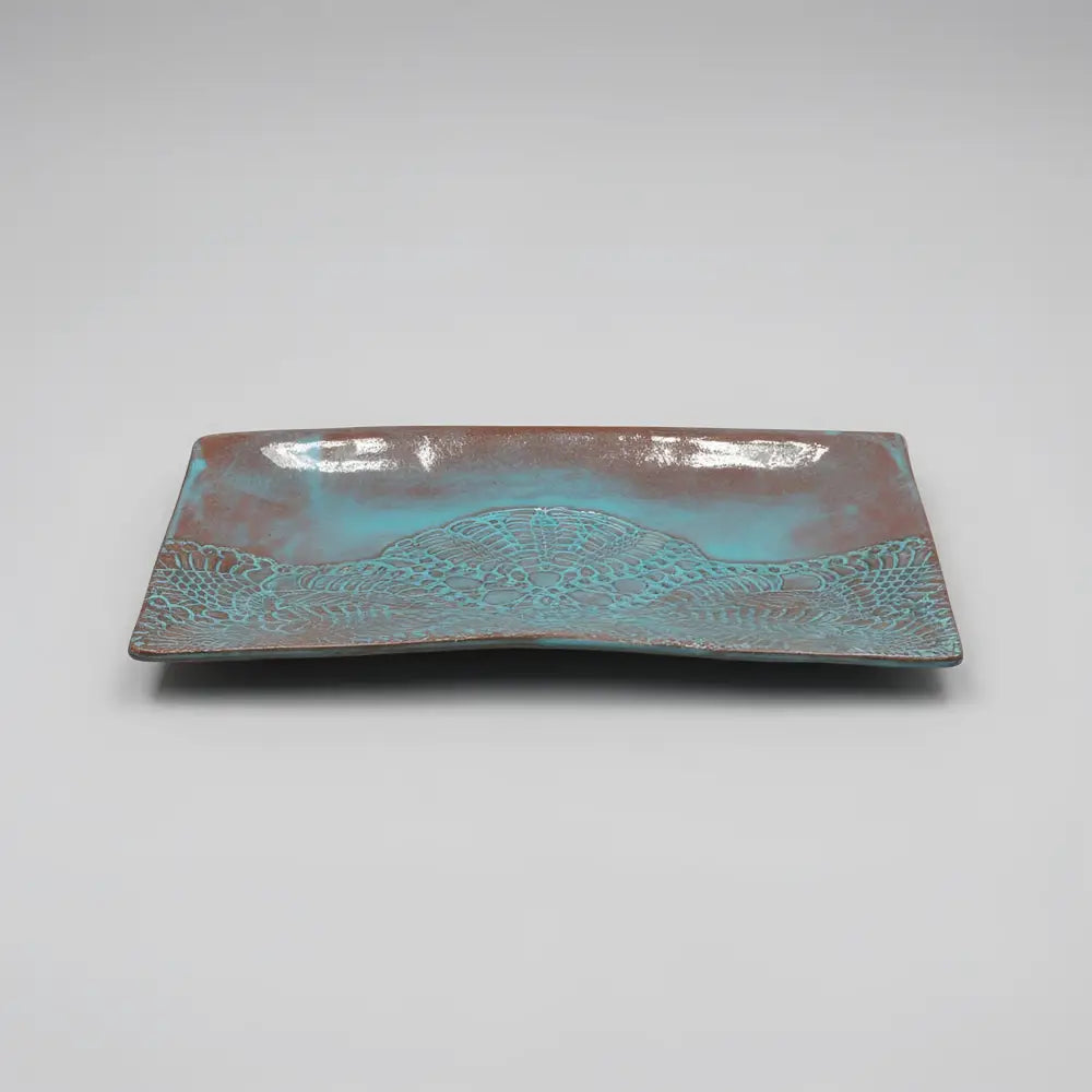 Handmade stoneware serving platter with embossed lace pattern