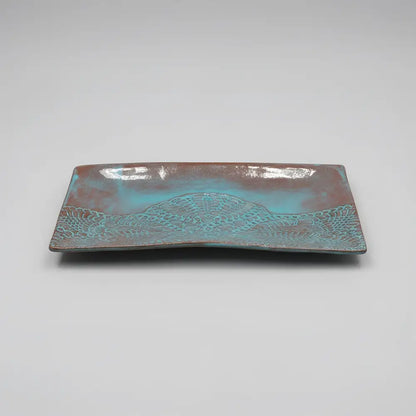 Handmade stoneware serving platter with embossed lace pattern