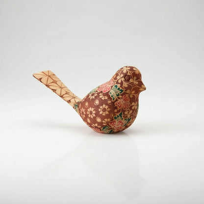 Handmade wooden bird figurine with floral and geometric batik pattern for home decor