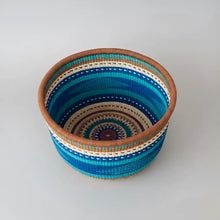 Handwoven African market basket from Bolgatanga with colorful blue and green stripes