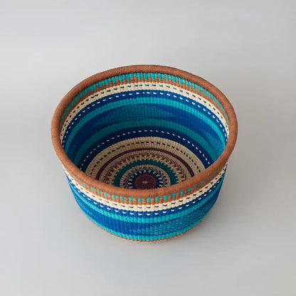 Handwoven African market basket from Bolgatanga with colorful blue and green stripes
