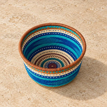 Handwoven bolgatanga african market basket with vibrant blue teal and cream stripes and geometric patterns for storage