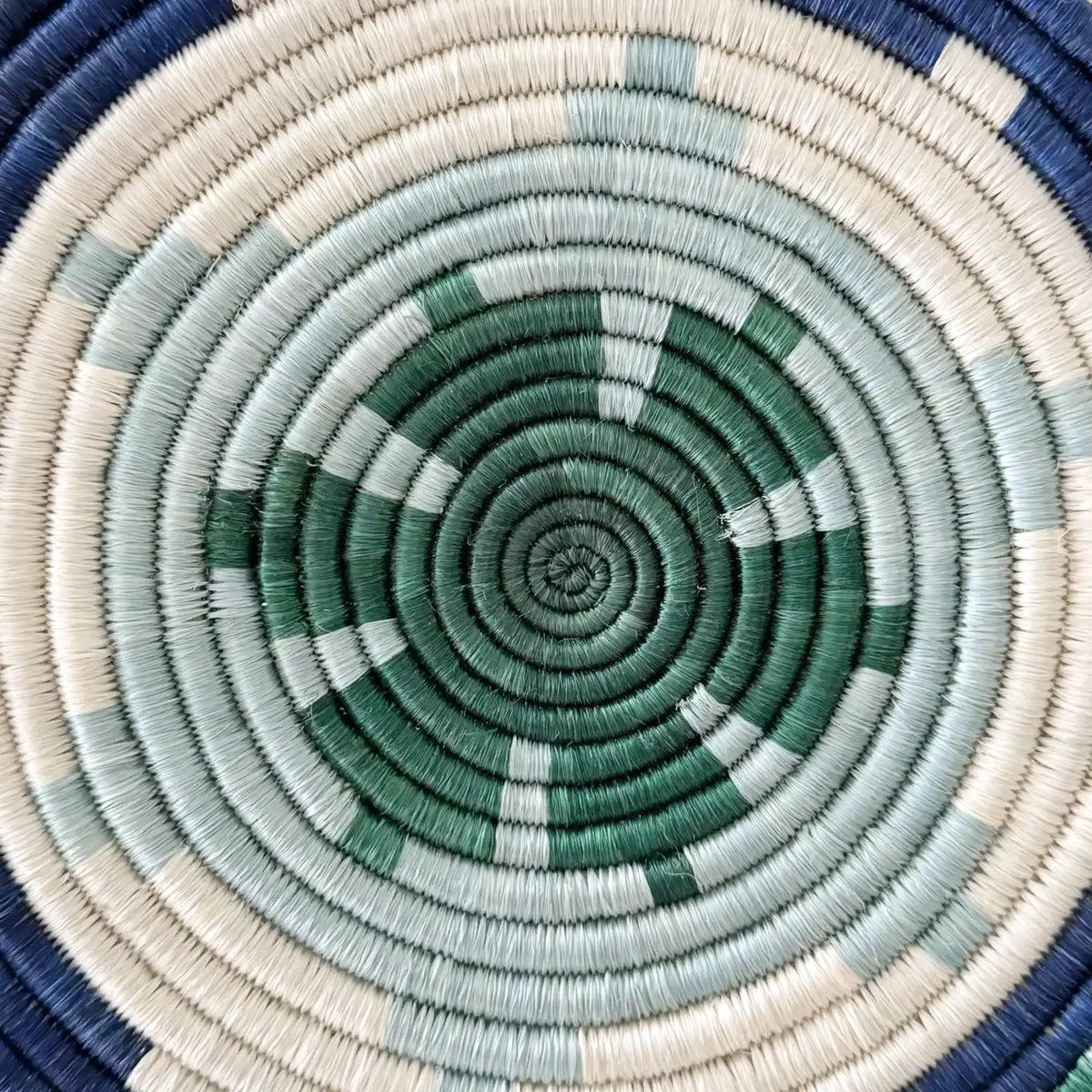 Handwoven african sisal trivet with geometric stars in green blue and cream circular design