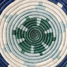 Handwoven african sisal trivet with geometric stars in green blue and cream circular design