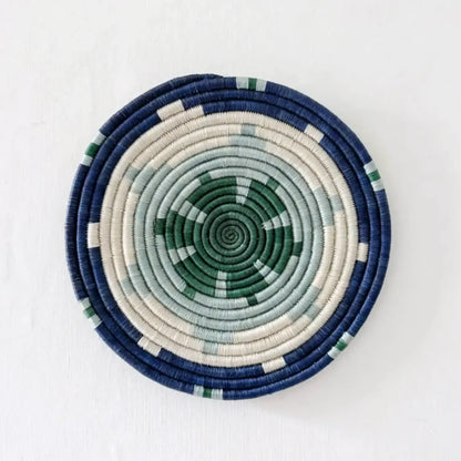 Handwoven african sisal trivet with geometric stars pattern in navy blue cream and green concentric rings