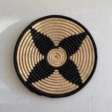 Handwoven african zulu trivet in black and beige woven from ilala palm and wild grasses featuring a spiral pattern from south africa