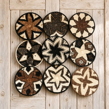 Nine handwoven african zulu trivets in black star pattern made from ilala palm and wild grasses from south africa