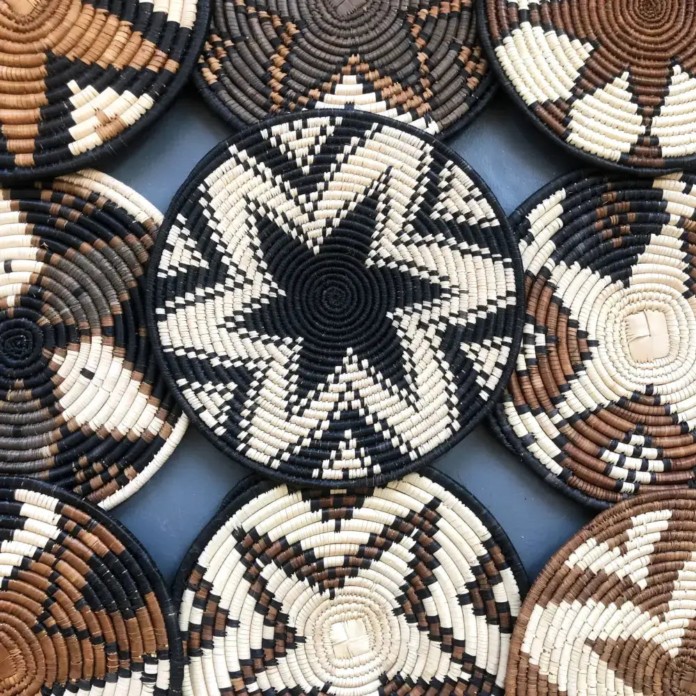 Handwoven african zulu trivet in black star pattern made from ilala palm and wild grasses from south africa