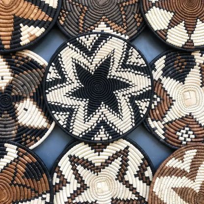 Handwoven african zulu trivet in black star pattern made from ilala palm and wild grasses from south africa