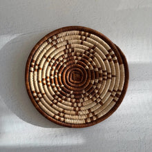 Handwoven african zulu trivet made of ilala palm and wild grasses with brown star design and natural cream tones from south africa