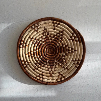 Handwoven african zulu trivet made of ilala palm and wild grasses with brown star design and natural cream tones from south africa