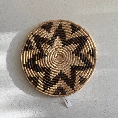Handwoven african zulu trivet featuring taupe and natural ilala palm wild grasses in a circular spiral pattern from south africa