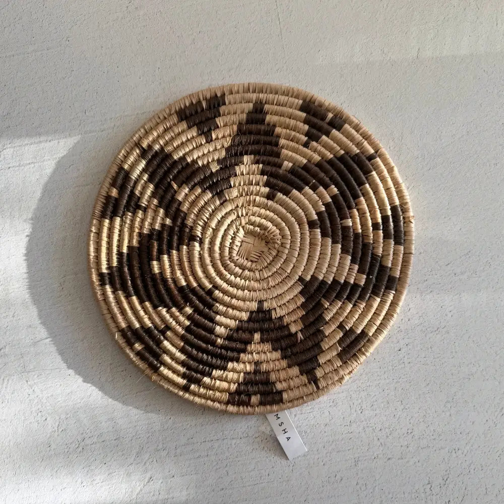 Handwoven african zulu trivet made from ilala palm and wild grasses with taupe star spiral design from south africa