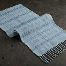 Light blue handwoven calado table runner with decorative stripes and fringe in recycled denim thread