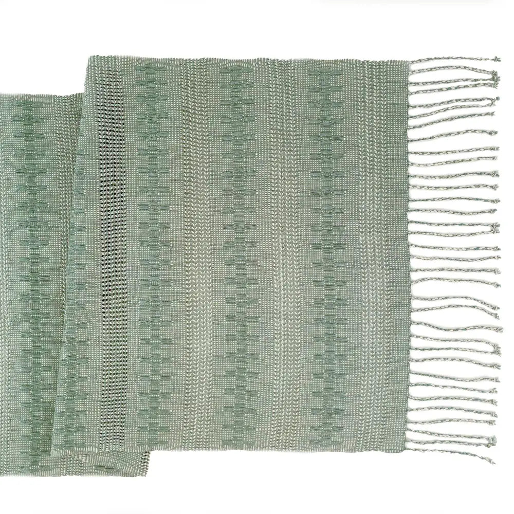 Table runner featuring sage green threads handwoven together in an intricate open weave technique called Calado.