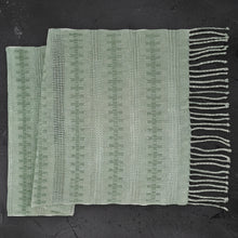 Light green handcrafted calado table runner with vertical stripes and fringe detail