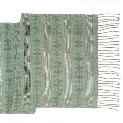Table runner featuring sage green threads handwoven together in an intricate open weave technique called Calado.