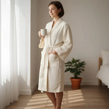 Cream-colored plush terry cloth robe in cotton nope yarn with belt and pockets