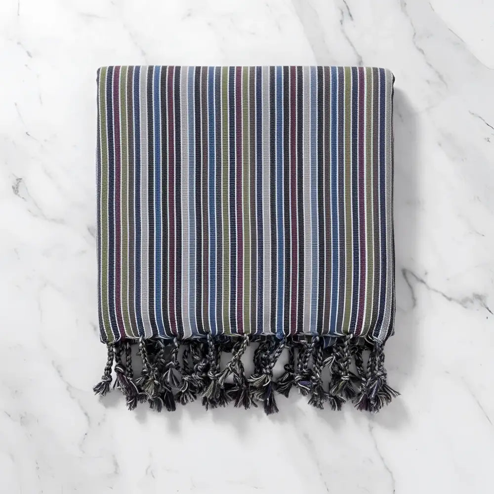 Handwoven earthy striped turkish hand towel with muted blue green purple and gray stripes and dark gray tassels