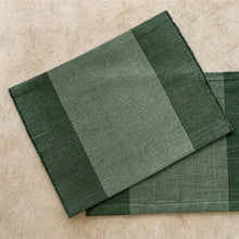 Handwoven ethiopian cotton placemat in dark and olive green stripes with textured weave fair trade certified